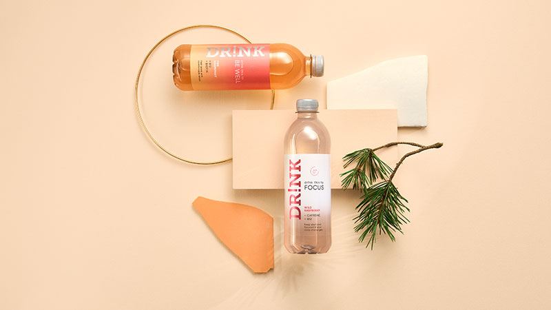 A group of bottles and a branchAI-generated content may be incorrect.